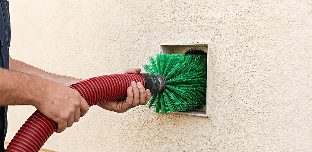 Air duct cleaning brush removing debris from a vent opening in Boston, MA