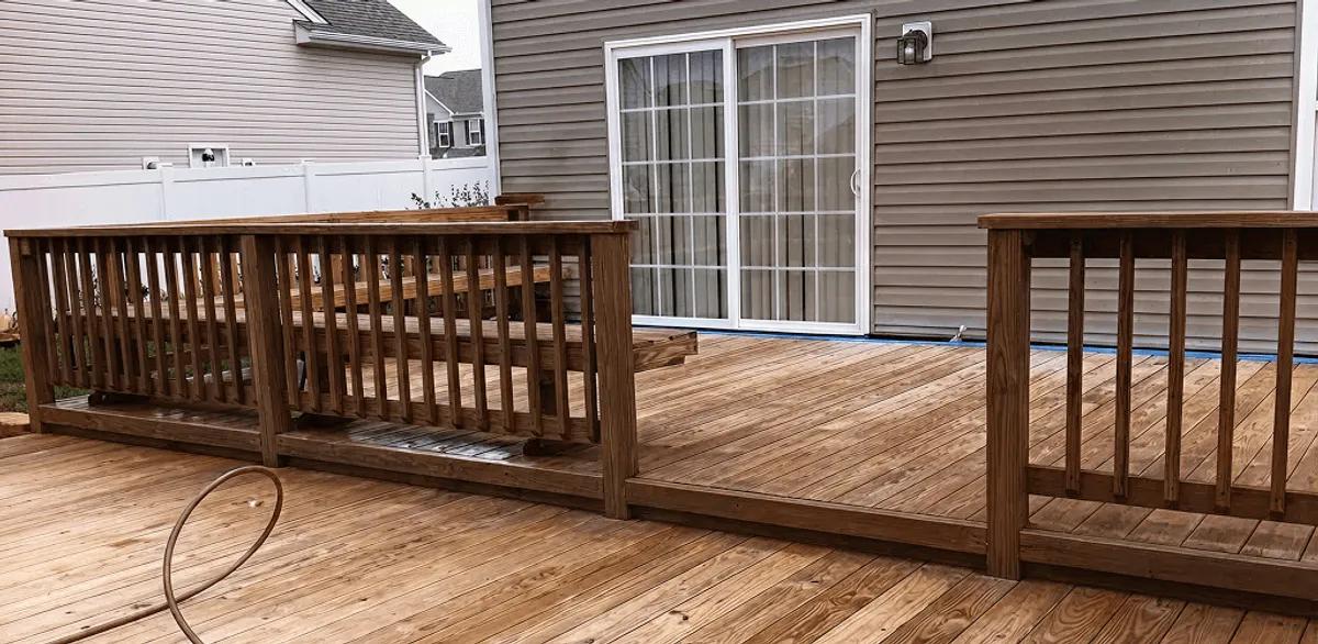 Deck sealing service protecting a backyard wood deck and railings in Boston, MA