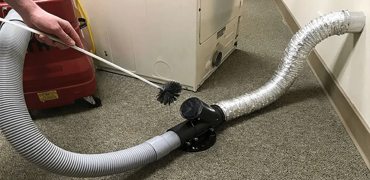 Dryer vent cleaning service removing lint from a dryer duct connection in Boston, MA