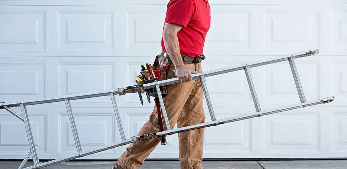 Garage door repair technician arriving with tools and ladder in Boston, MA