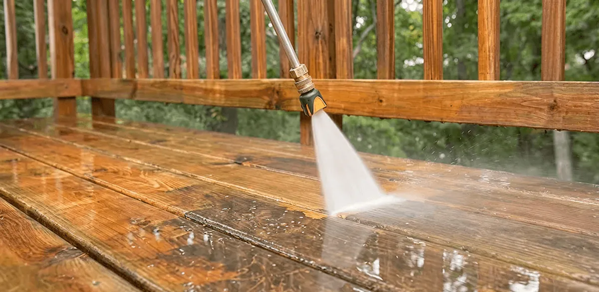 Pressure washing a wood deck to remove dirt and buildup in Boston, MA