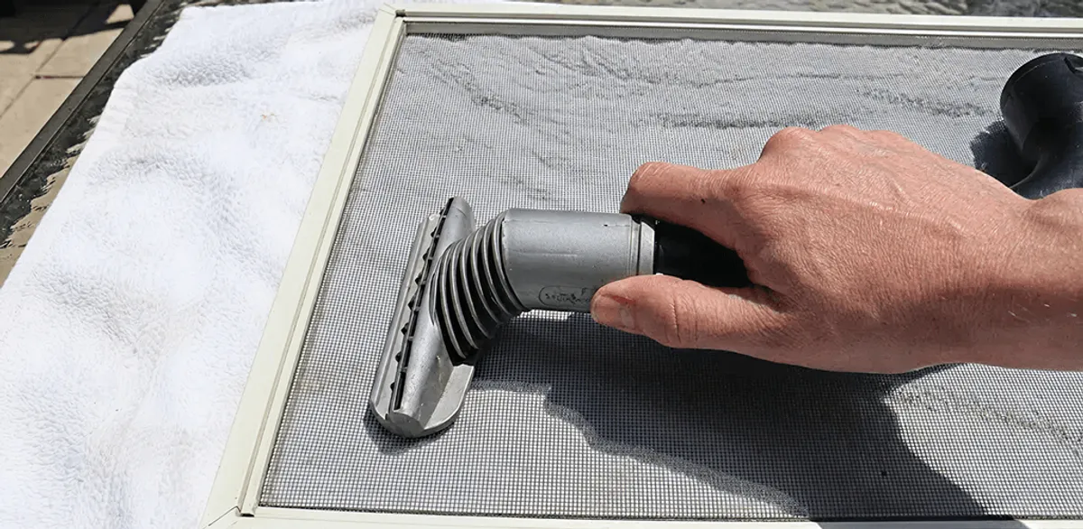 Window screen repair cleaning and fixing a damaged screen mesh in Boston, MA